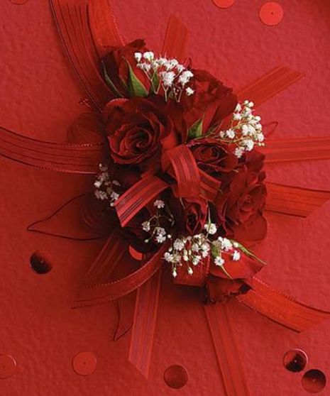Rich red spray roses accented with babies breath and red ribbons.
