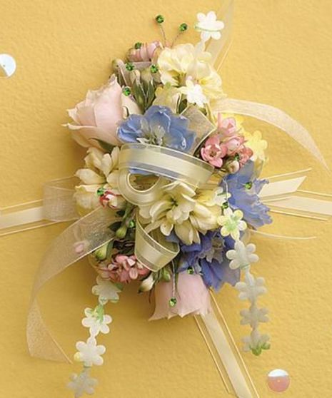 Small blossoms of spray roses, stock, delphinium accented with filler and greenery, sheer ribbons.