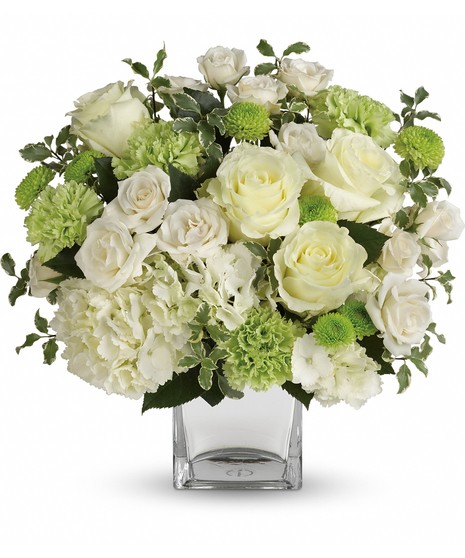  blooms includes white hydrangea, white roses, white spray roses, green carnations, green button spray chrysanthemums, and pitta negra